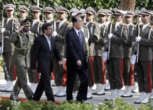 The president of the Presidium of North Korea's Supreme People's Assembly Kim Yong-nam, reviews an honor guard alongside Iranian President Mahmoud Ahmadinejad, during an official welcoming ceremony in Tehran, Iran, Saturday, Sept. 1, 2012. (Photo Credit: AP)