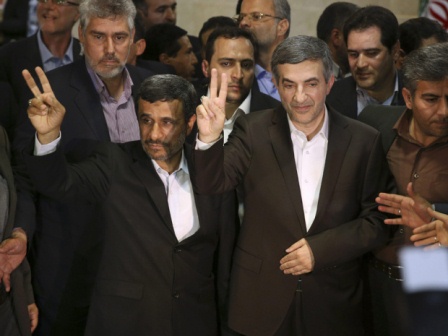 Iranian President Mahmoud Ahmadinejad, left, and his close ally Esfandiar Rahim Mashaei flash victory signs, as they arrive at the election headquarters of the interior ministry for registering of Rahim Mashaei for the upcoming presidential election, in Tehran, Iran, Saturday, May 11, 2013.(Photo Credit: Ebrahim Noroozi/AP)