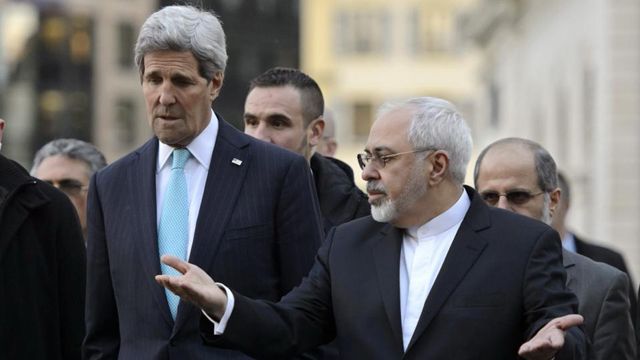U.S. Secretary of State John Kerry (left) and Iranian Foreign Minister Mohammad Javad Zarif walk in sideline of nuclear talks in Geneva.