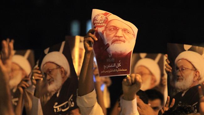 Bahraini demonstrators attend a protest against the revocation of the citizenship of top Shia cleric, Sheikh Isa Qassim, near Qassim's house in the village of Diraz, west of Manama.