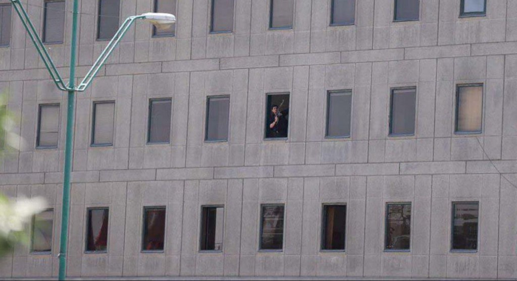 Iranian security officer is seen inside the Parliament building.