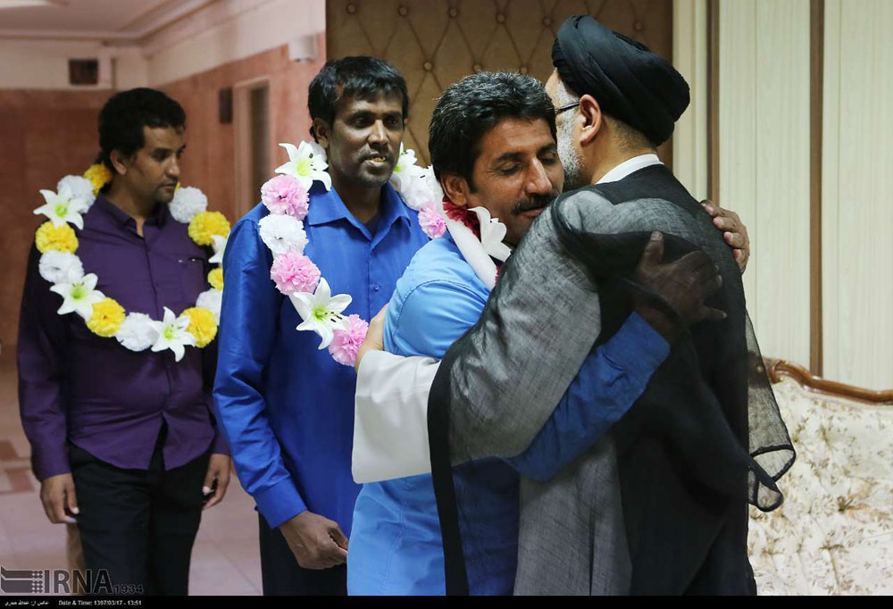 Iran's Intel Minister Mahmoud Alavi hugs the recently freed hostages in Tehran on "Friday".